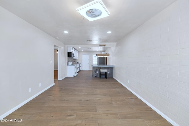 unfurnished living room with hardwood / wood-style floors