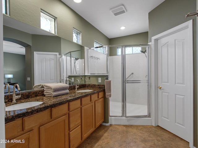 bathroom with vanity, walk in shower, and lofted ceiling