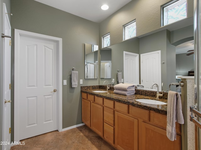 bathroom with tile patterned flooring, vanity, and ceiling fan