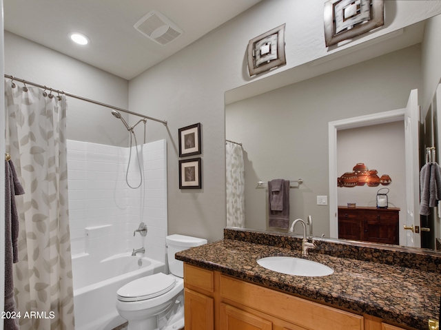 full bathroom featuring vanity, shower / bath combination with curtain, and toilet