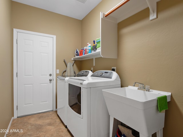 washroom featuring separate washer and dryer and sink