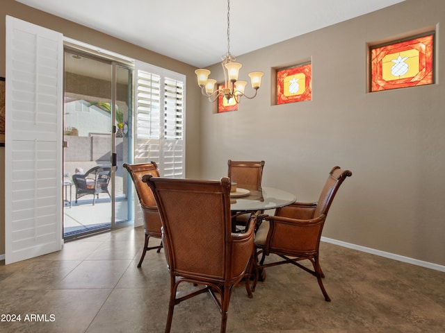 dining room featuring tile patterned flooring and a chandelier