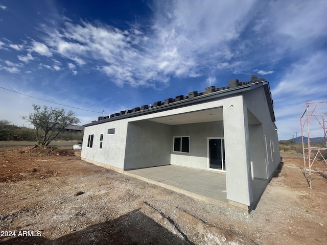 back of house with a patio