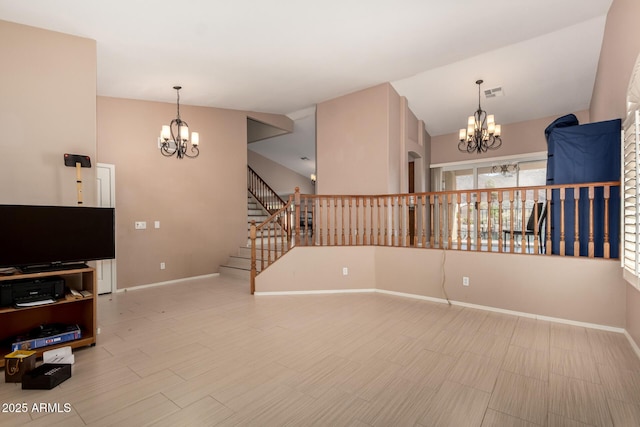 unfurnished living room with an inviting chandelier, baseboards, stairs, and visible vents