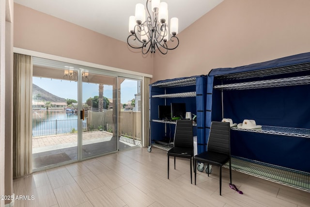 bedroom with access to outside, multiple windows, lofted ceiling, and a chandelier
