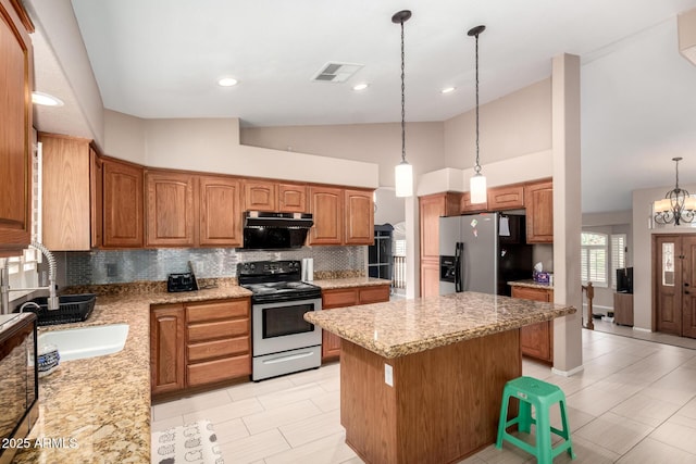 kitchen with decorative backsplash, lofted ceiling, range with electric stovetop, stainless steel fridge with ice dispenser, and a sink