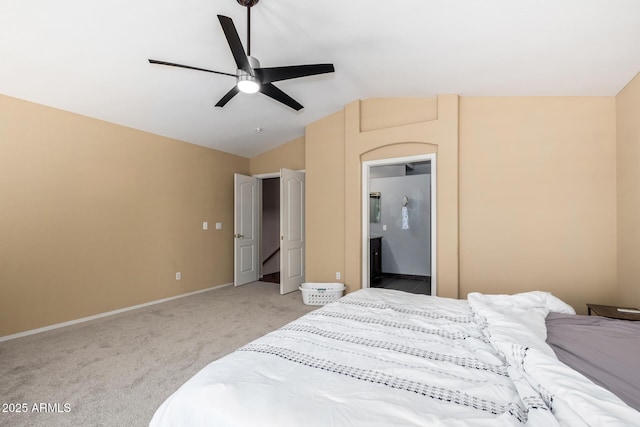 bedroom with a ceiling fan, light colored carpet, vaulted ceiling, baseboards, and connected bathroom