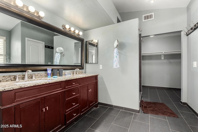 bathroom featuring a sink, baseboards, tile patterned flooring, and visible vents