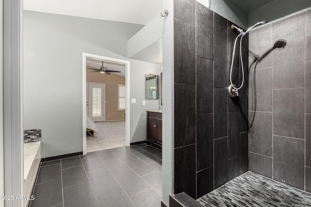 full bathroom with vanity, tile patterned flooring, baseboards, a ceiling fan, and a tile shower