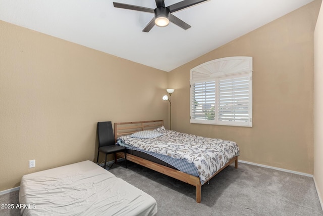 carpeted bedroom with baseboards, ceiling fan, and vaulted ceiling