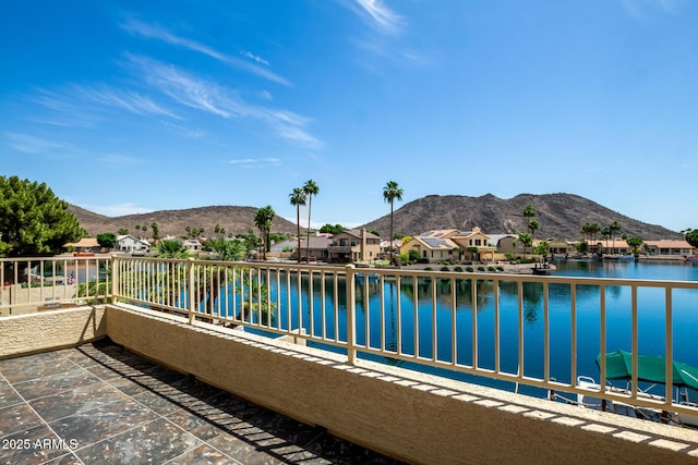 balcony with a water and mountain view and a residential view