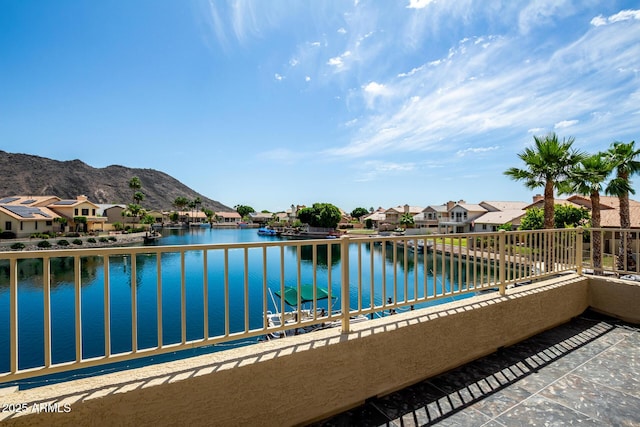 balcony with a residential view and a water and mountain view