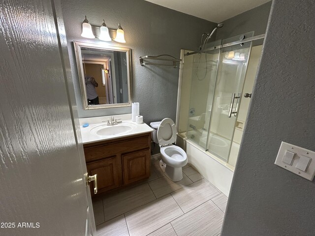 20713 N 56th Ave, Glendale, AZ 85308 - bathroom with a textured wall, vanity, bath / shower combo with glass door, tile patterned flooring, and toilet