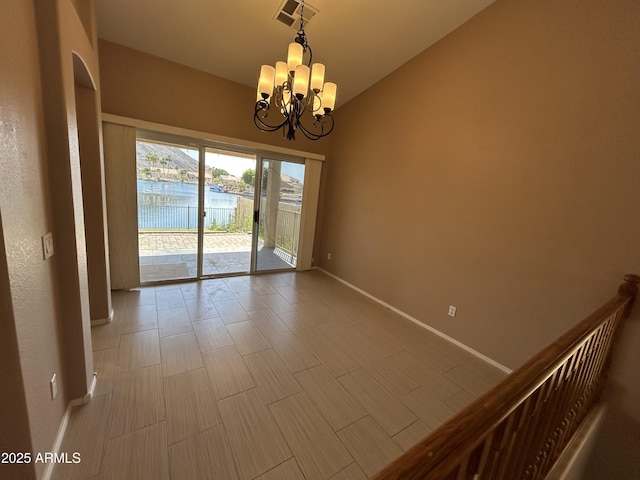 20713 N 56th Ave, Glendale, AZ 85308 - unfurnished room with baseboards, a chandelier, lofted ceiling, and a water view