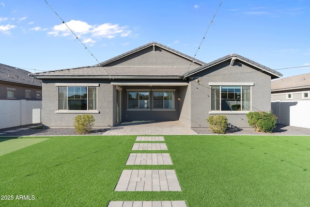 back of property featuring a patio and a yard