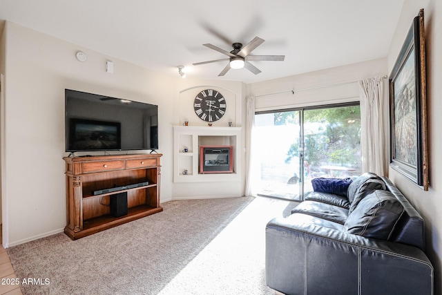 carpeted living room with ceiling fan