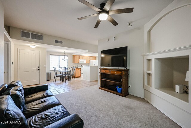 living room with light carpet and ceiling fan