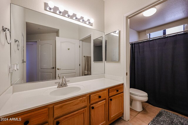 bathroom with tile patterned floors, vanity, and toilet