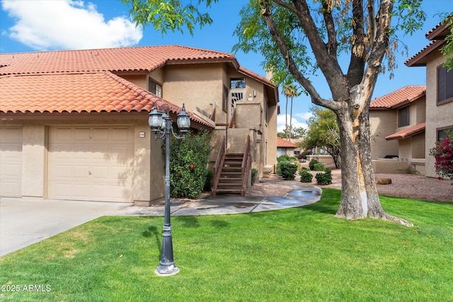 mediterranean / spanish-style house with a tiled roof, concrete driveway, a front yard, stucco siding, and an attached garage