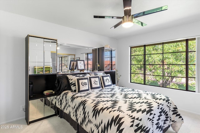 carpeted bedroom with multiple windows, baseboards, and ceiling fan