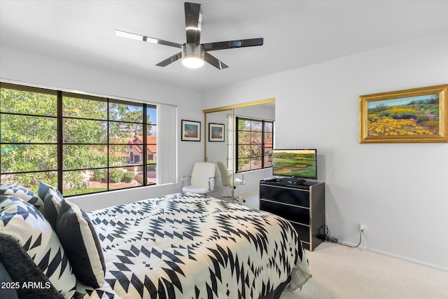 bedroom with a closet, baseboards, carpet, and a ceiling fan