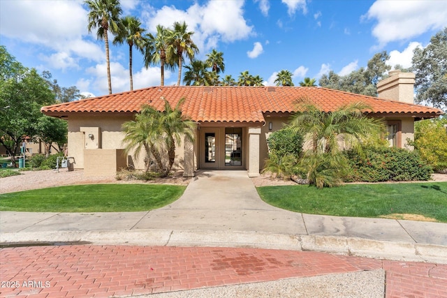 mediterranean / spanish home featuring stucco siding and a tile roof