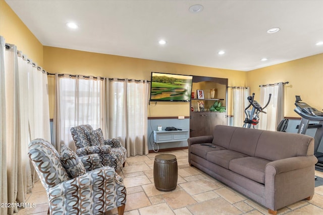 living area with recessed lighting and stone tile flooring