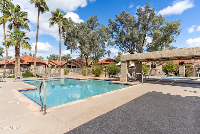 pool featuring a patio area and fence