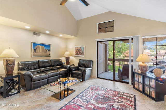 living room with visible vents, high vaulted ceiling, a ceiling fan, and tile patterned flooring