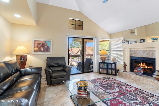 living room with recessed lighting, a tile fireplace, and high vaulted ceiling