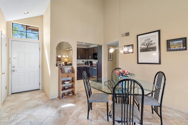 dining area featuring visible vents, baseboards, recessed lighting, arched walkways, and high vaulted ceiling