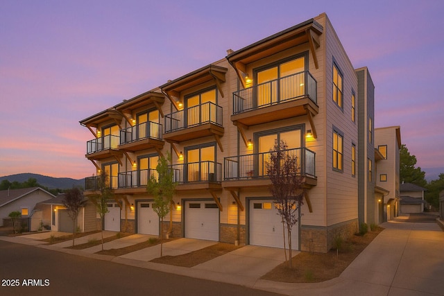 613 N Beaver St Unit 5, Flagstaff, AZ 86001 - townhome / multi-family property with a garage, driveway, stone siding, and a balcony
