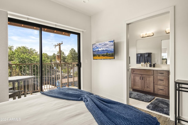 613 N Beaver St Unit 5, Flagstaff, AZ 86001 - bedroom featuring baseboards, ensuite bathroom, wood finished floors, and access to outside