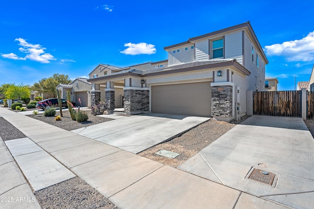 view of front of property with fence, driveway, stone siding, and stucco siding