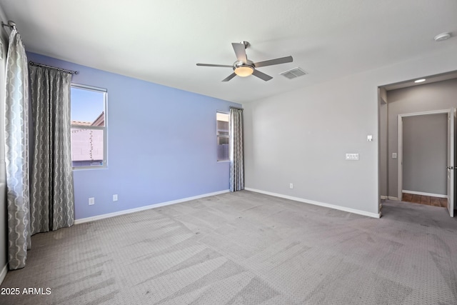 unfurnished bedroom featuring baseboards, a ceiling fan, carpet flooring, and visible vents