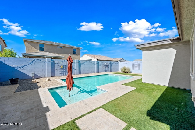 view of swimming pool with a lawn, a fenced in pool, a fenced backyard, and a patio area