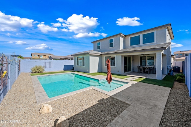 rear view of property featuring central AC unit, a fenced in pool, a fenced backyard, a patio, and stucco siding