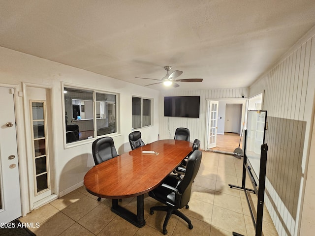 office featuring french doors, light tile patterned flooring, and a ceiling fan