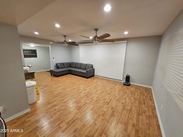 living room with light wood-style floors, baseboards, and recessed lighting