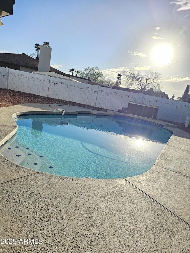 view of swimming pool featuring a fenced backyard and a fenced in pool