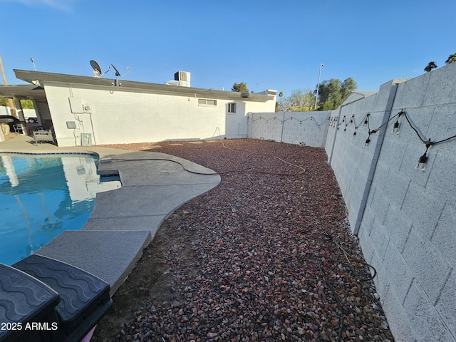 view of yard featuring a patio area, a fenced backyard, and a fenced in pool