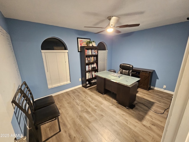 office featuring ceiling fan, light wood finished floors, and baseboards