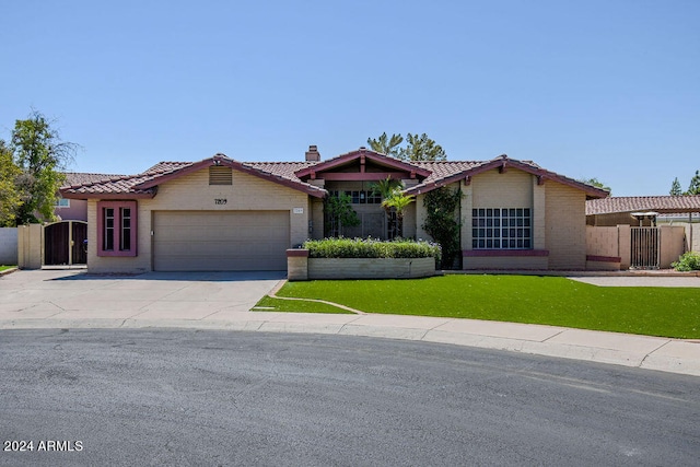 view of front of home with a front lawn and a garage