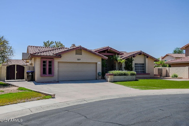 mediterranean / spanish home with a front lawn and a garage