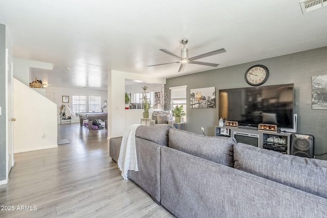 living area with visible vents, light wood finished floors, ceiling fan, and pool table