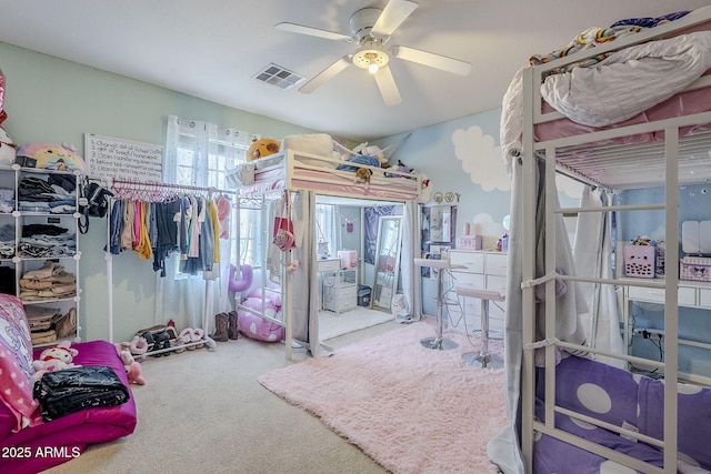 carpeted bedroom featuring a ceiling fan and visible vents