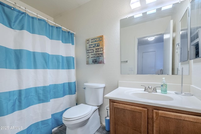 full bathroom with vanity, toilet, and curtained shower
