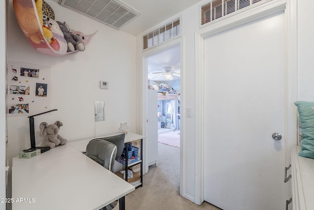 office with a ceiling fan, visible vents, and light carpet
