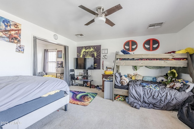 carpeted bedroom featuring ceiling fan and visible vents