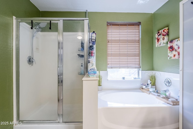 full bathroom featuring a stall shower and a bath